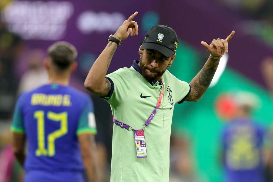 Neymar celebrates Brazil topping Group G, despite a shock 1-0 defeat to Cameroon