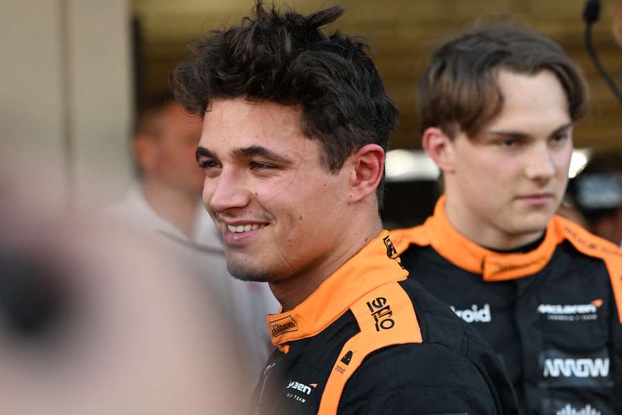 McLaren's Lando Norris (R) and Oscar Piastri (L) celebrate after finishing second and third in the qualifying session