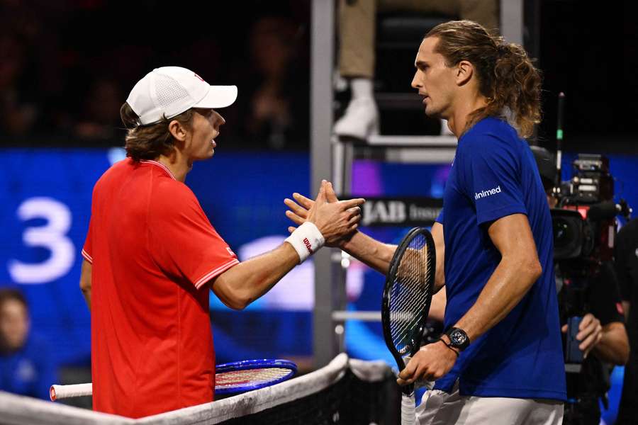 De Minaur (left) shakes hands with Zverev at the net De Minaur (left) shakes hands with Zverev at the net