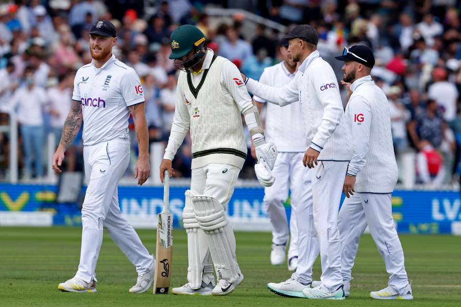 Australia's Nathan Lyon (C) is congratulated by England players after losing his wicket on day four of the second Ashes Test