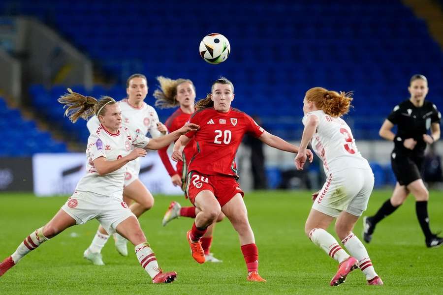 Wales' Carrie Jones and Denmark's Josefine Hasbo (left) and Stine Pedersen (right) battle for the ball