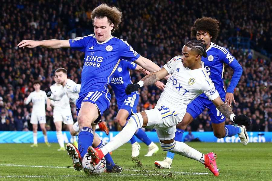 Crysencio Summerville in duel met Wout Faes van Leicester City