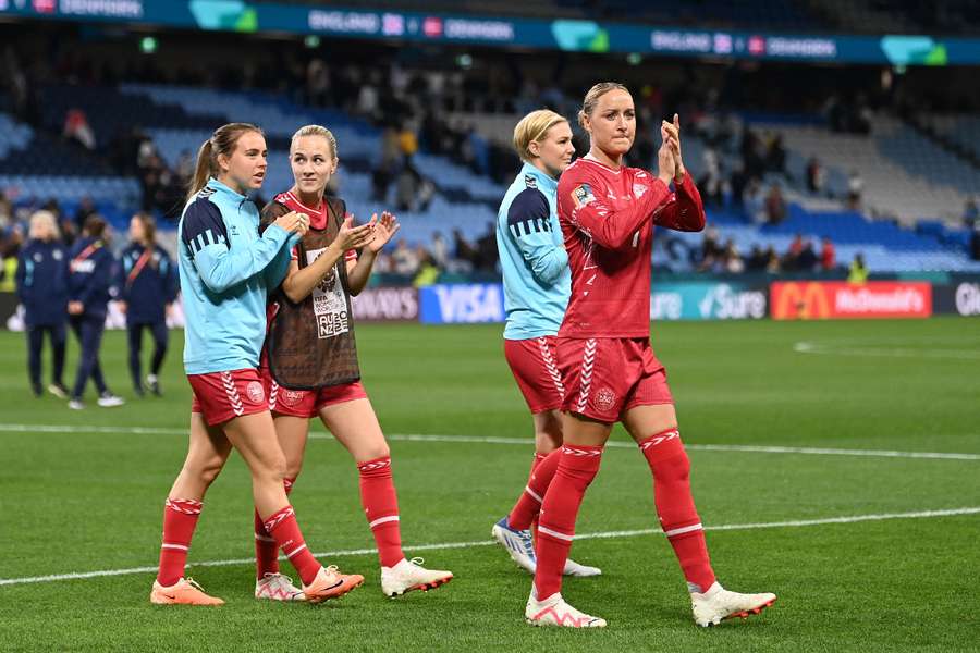 Denmark players applaud fans after the match