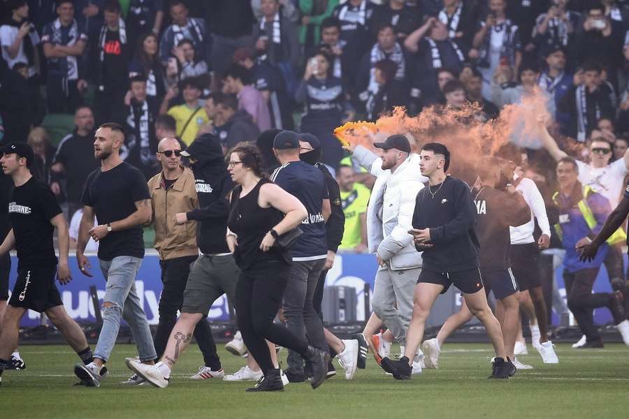 More than 100 fans stormed the pitch during the Melbourne derby