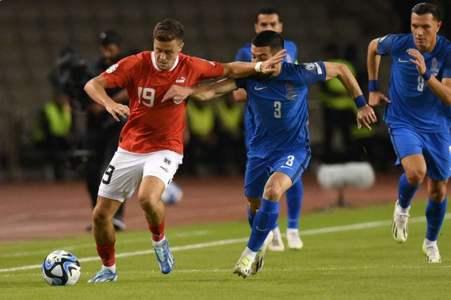 Christoph Baumgartner takes on Azerbaijan's Elvin Cafarquliyev on the wing