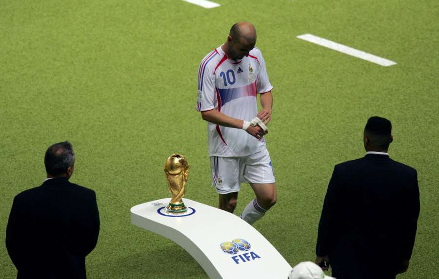 Zinedine Zidane walks past the World Cup trophy after receiving a red card in the final Zinedine Zidane walks past the World Cup trophy after receiving a red card in the final