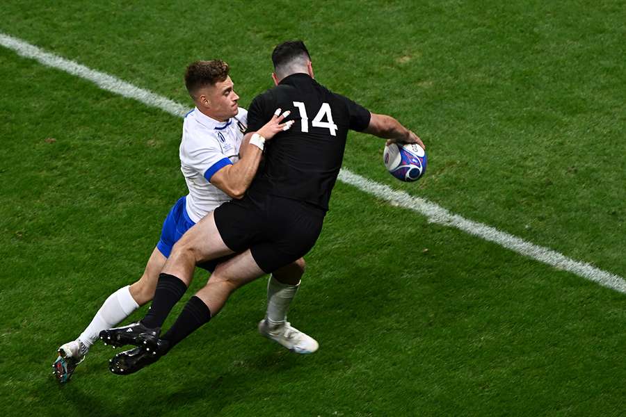 New Zealand's right wing Will Jordan (R) dives and scores a try as he is tackled by Italy's scrum-half Stephen Varney