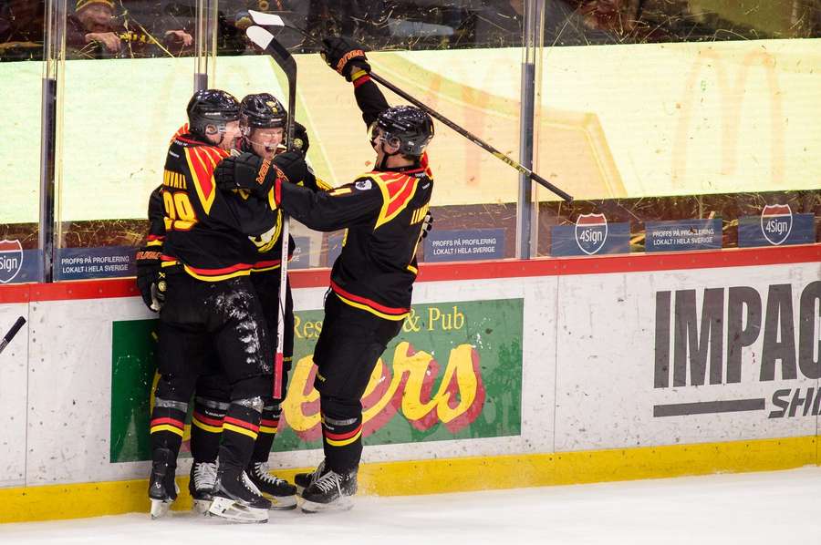 Linus Olund (centre) and teammates celebrate the first of his three goals