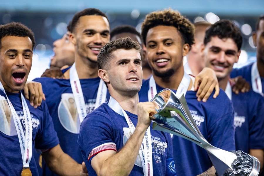 Christian Pulisic celebrates with teammates after beating Mexico to win the Concacaf Nations League final