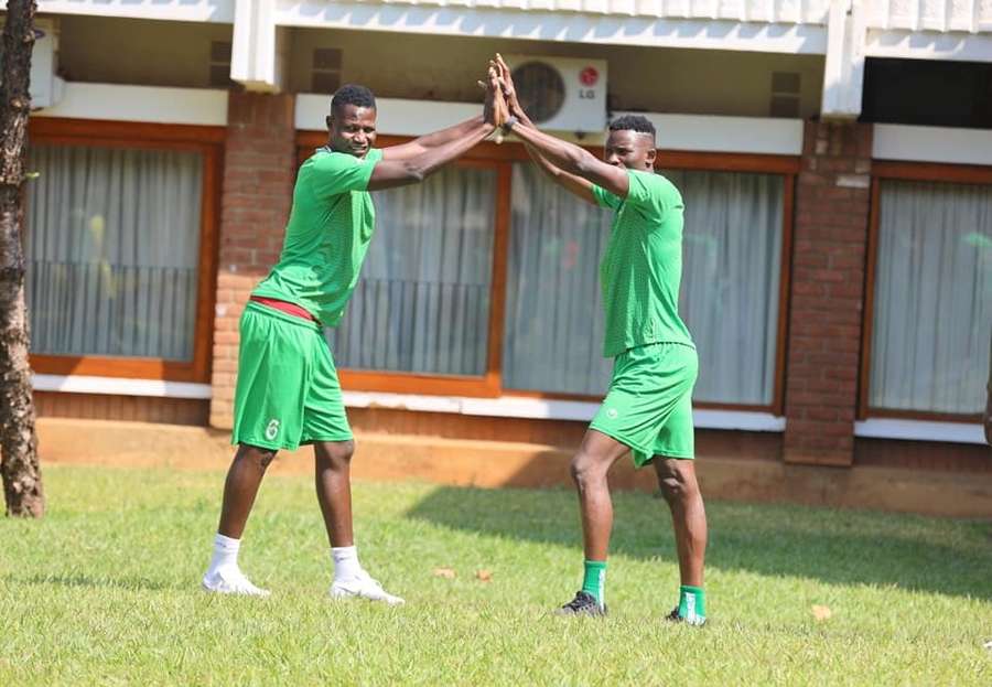 Harambee Stars midfielder Anthony Akumu with Michael Olunga in Malawi