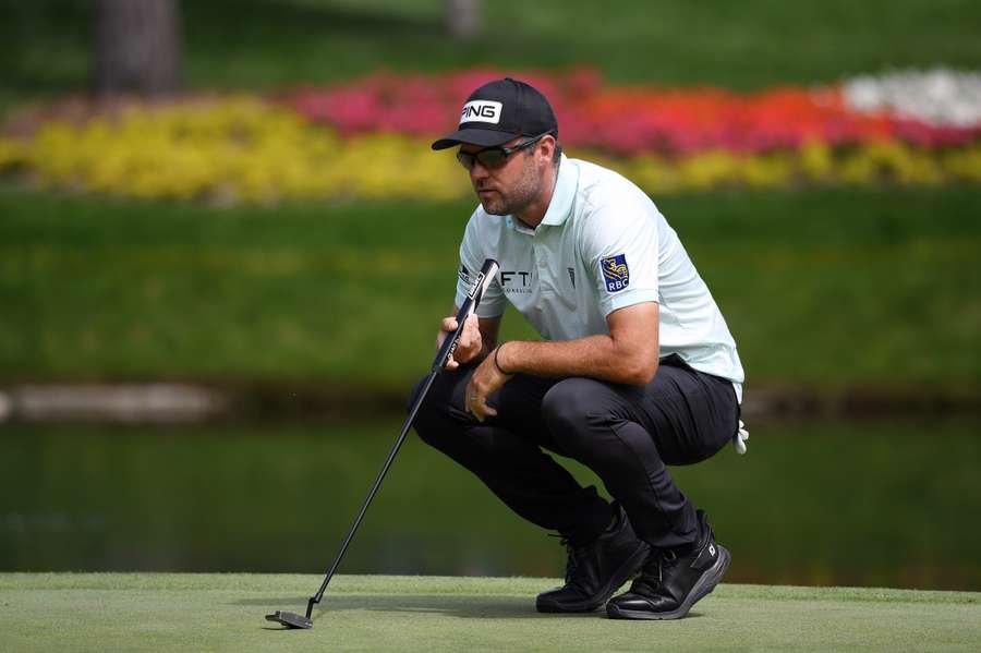 Corey Conners lines up a putt