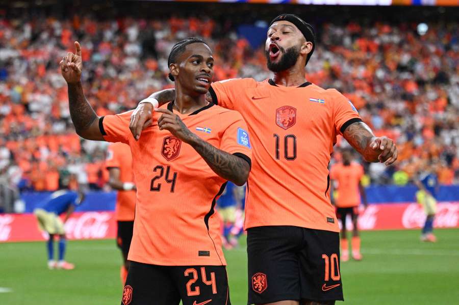 Netherlands' Crysencio Summerville celebrates scoring their fifth goal with Memphis Depay