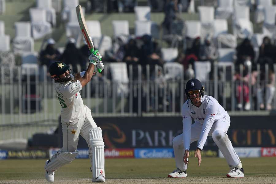 Pakistan's Mohammad Rizwan (L) plays a shot during the fifth and final day of the Test match between Pakistan and England