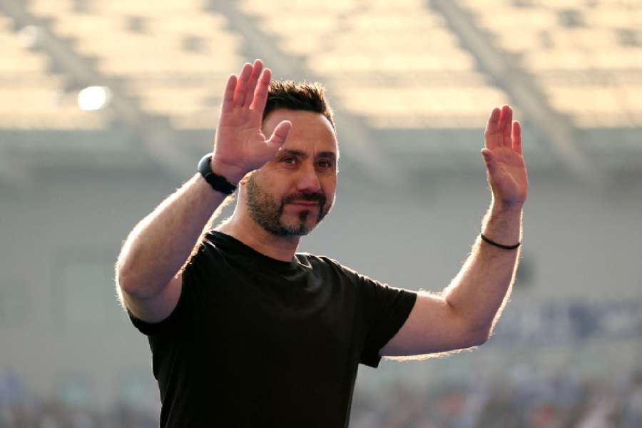 Roberto De Zerbi acknowledges fans during a lap of appreciation after their last game of the season and his final game as manager of Brighton