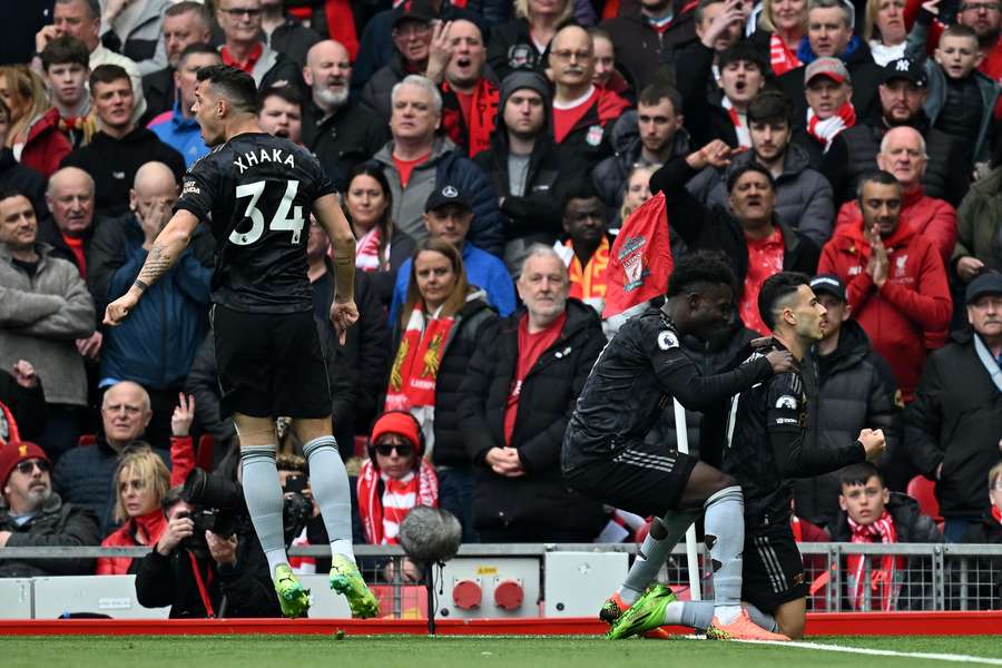 Martinelli (R) celebrates in front of the Liverpool fans