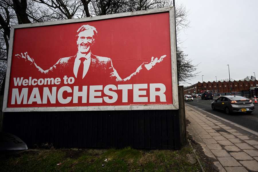 A photograph taken on February 4, 2024 shows a billboard depicting INEOS Chairman and Manchester United shareholder Sir Jim Ratcliffe