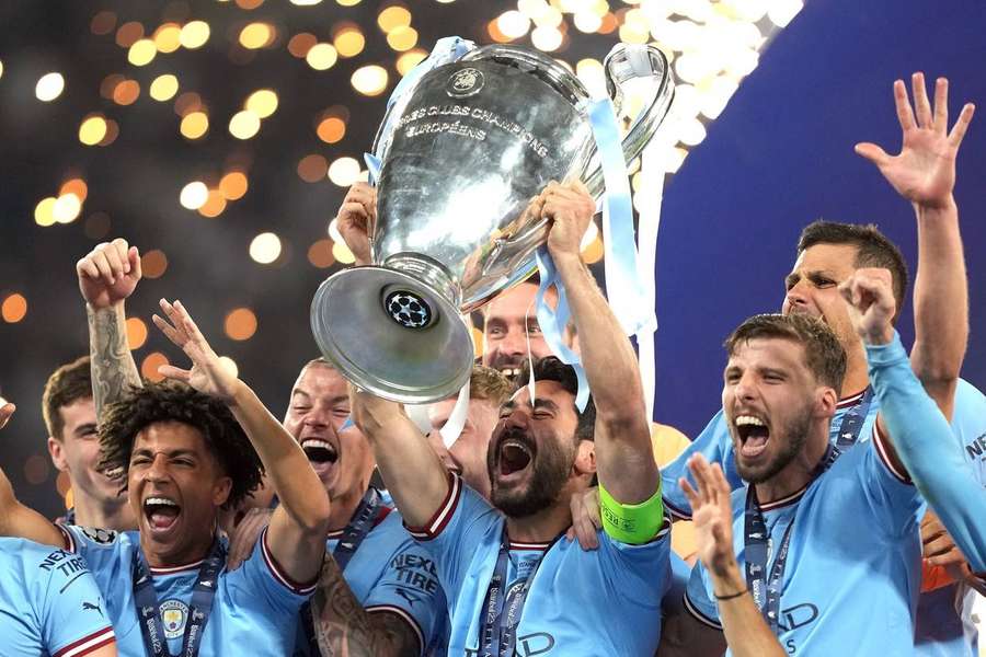 Manchester City players lifting the Champions League trophy in 2023