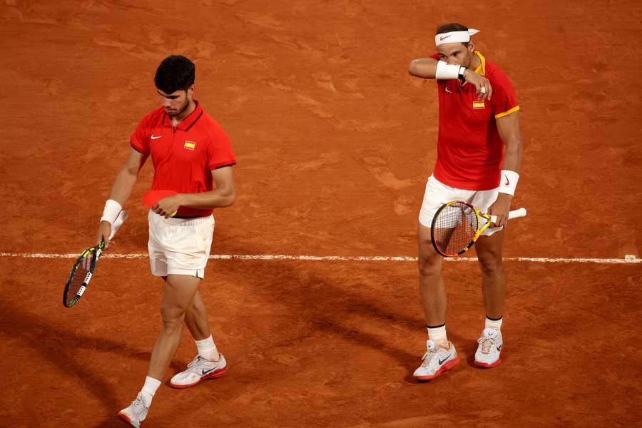 Carlos Alcaraz of Spain and Rafael Nadal of Spain react during their match