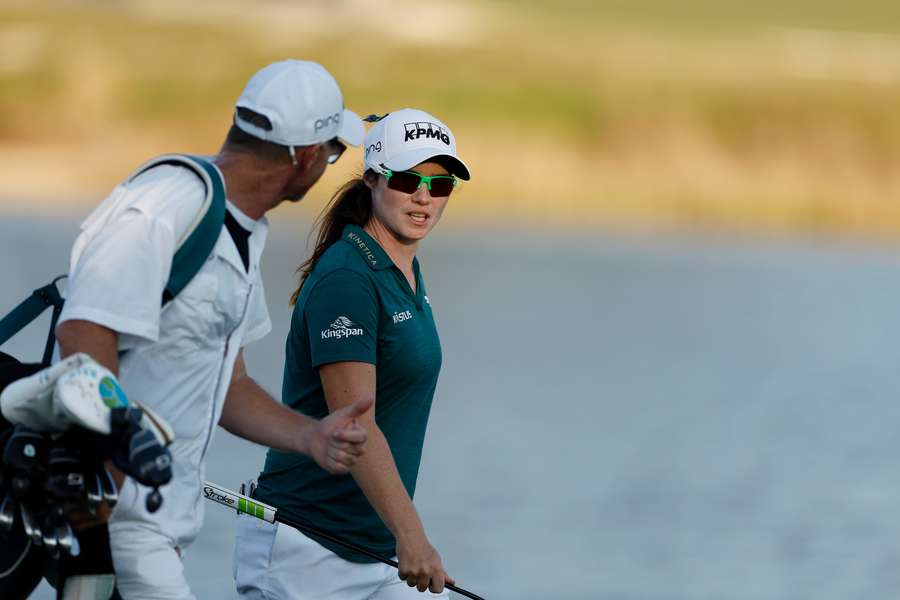 Maguire (C) talks with her caddy