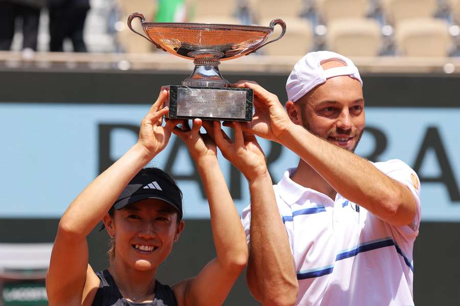 Japan's Miyu Kato (L) and Germany's Tim Puetz (R) celebrate holding their trophy