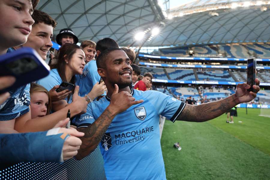 Douglas Costa takes photos with Sydney FC fans after their 3-2 A-League Mens win over Newcastle Jets. 