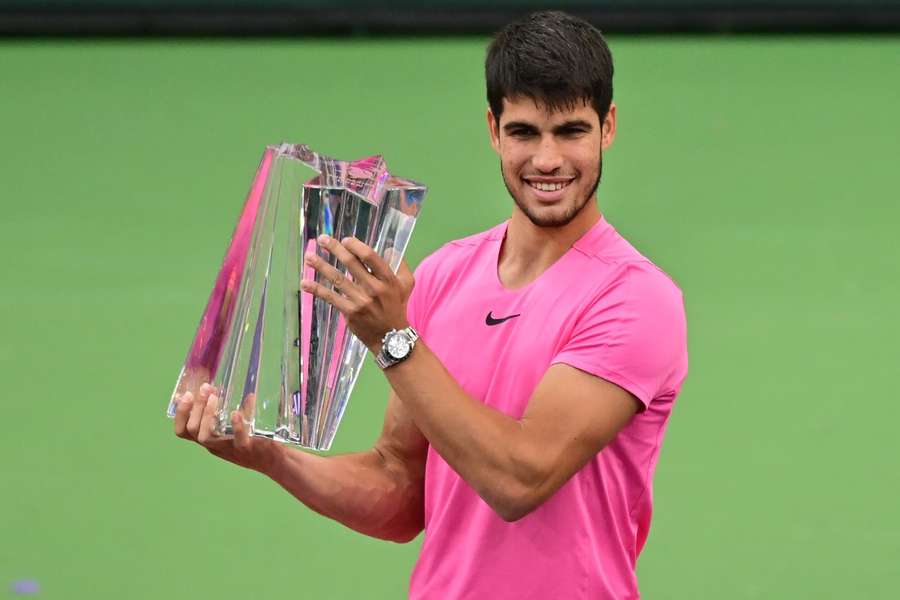 Carlos Alcaraz of Spain holds the championship trophy after defeating Daniil Medvedev of Russia