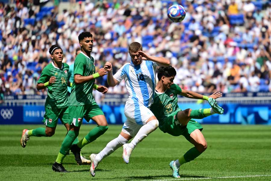 Lucas Beltran (centre) fights for the ball with Iraq's defender Hussein Amer (right)