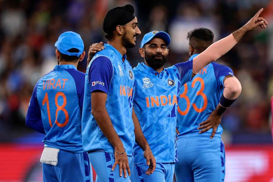 India's Arshdeep Singh (C) and Mohammed Shami celebrate their win