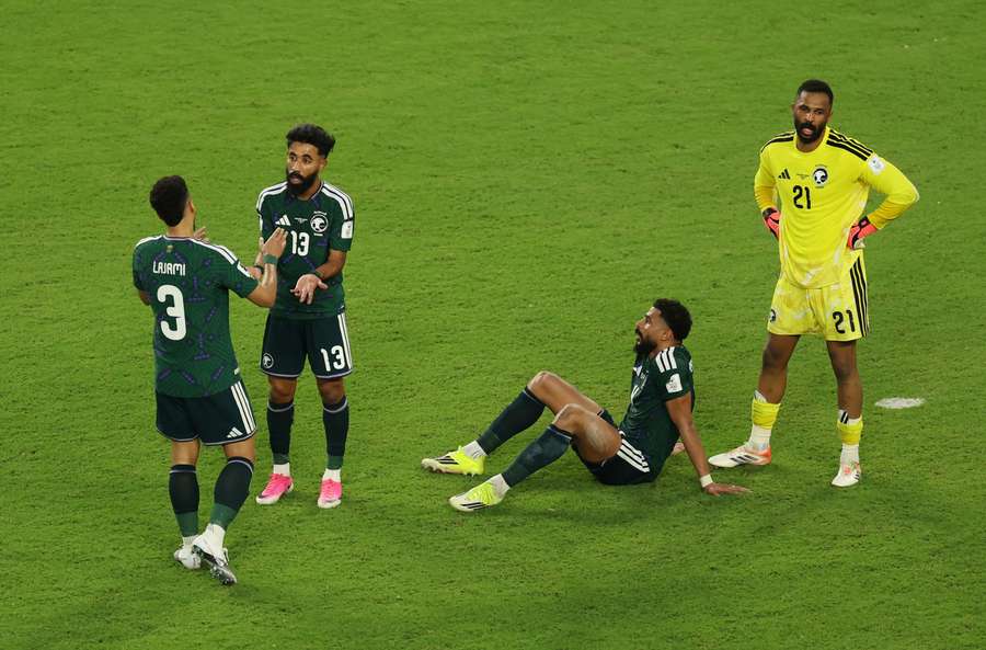 Saudi Arabia's Nawaf Bu Washl and teammates react after the match Saudi Arabia's Nawaf Bu Washl and teammates react after the match