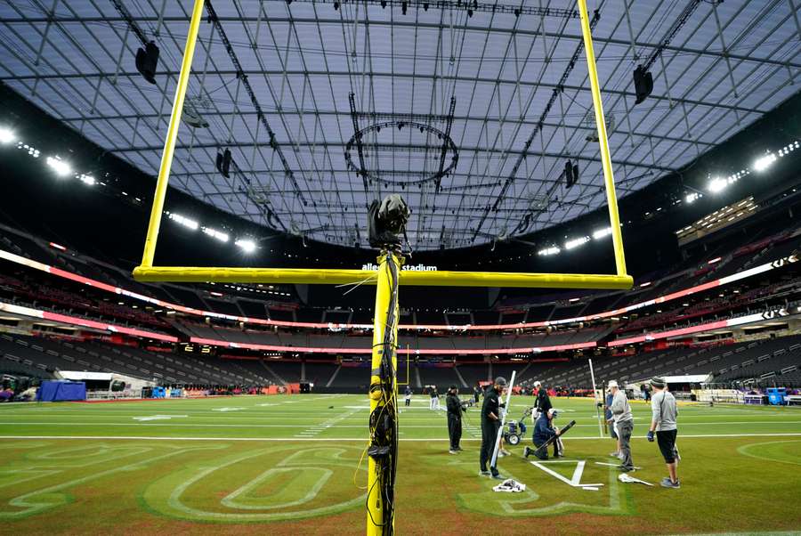 Workers paint the field at Allegiant Stadium in Las Vegas, Nevada