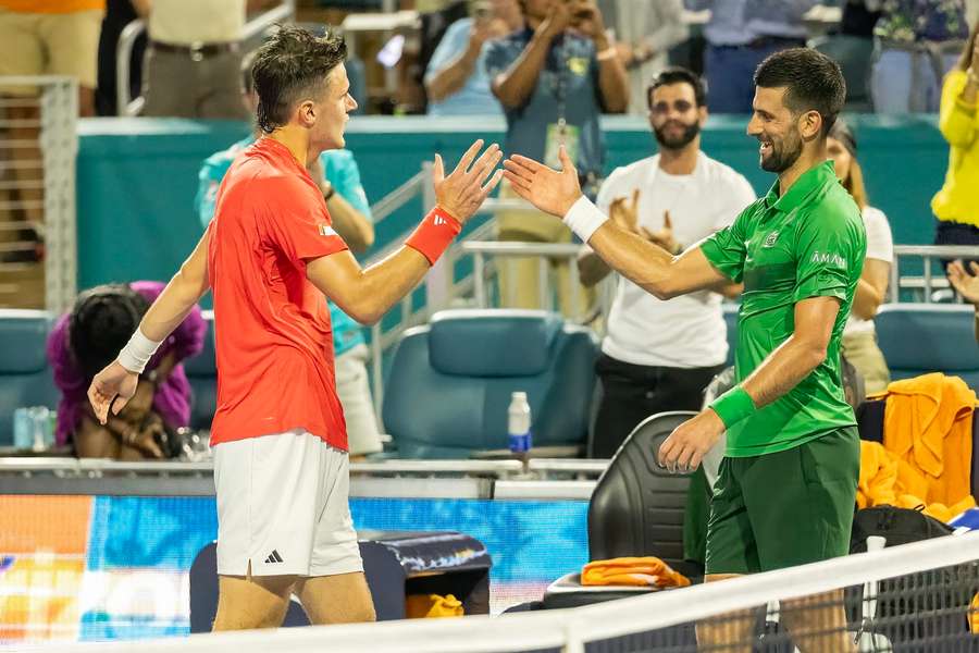 Mensik and Djokovic shake hands after the match