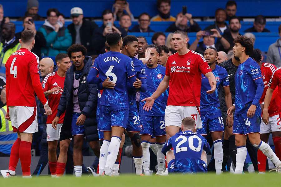 Nottingham Forest's Nikola Milenkovic clashes with Chelsea's Levi Colwill as Wesley Fofana intervenes