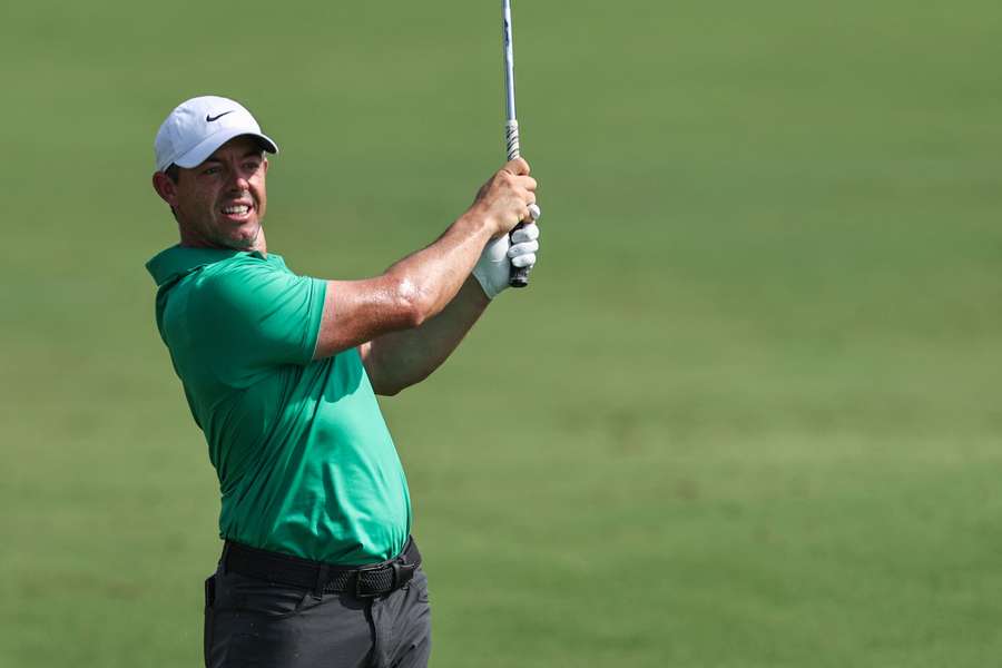 Rory McIlroy eyes the ball after playing a shot on the first hole during the DP World Tour Championship