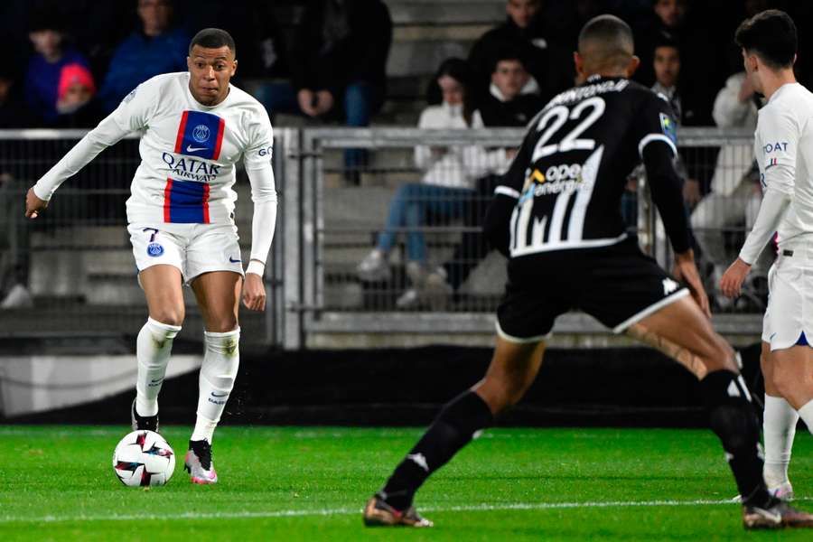 Paris Saint-Germain's French forward Kylian Mbappe fights for the ball