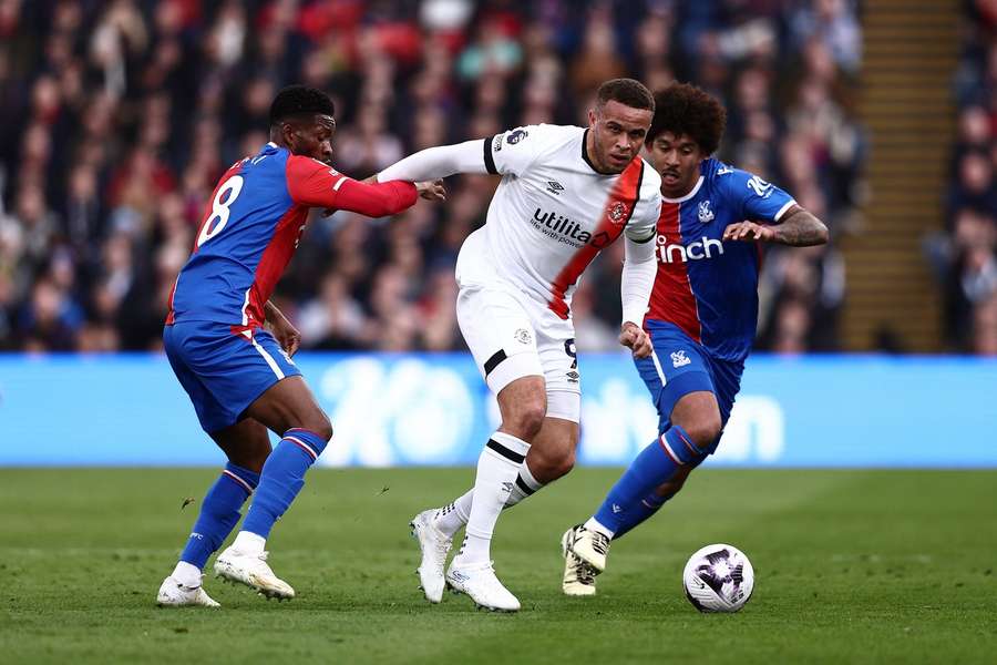 Carlton Morris of Luton Town on the ball whilst under pressure from Jefferson Lerma and Chris Richards of Crystal Palace