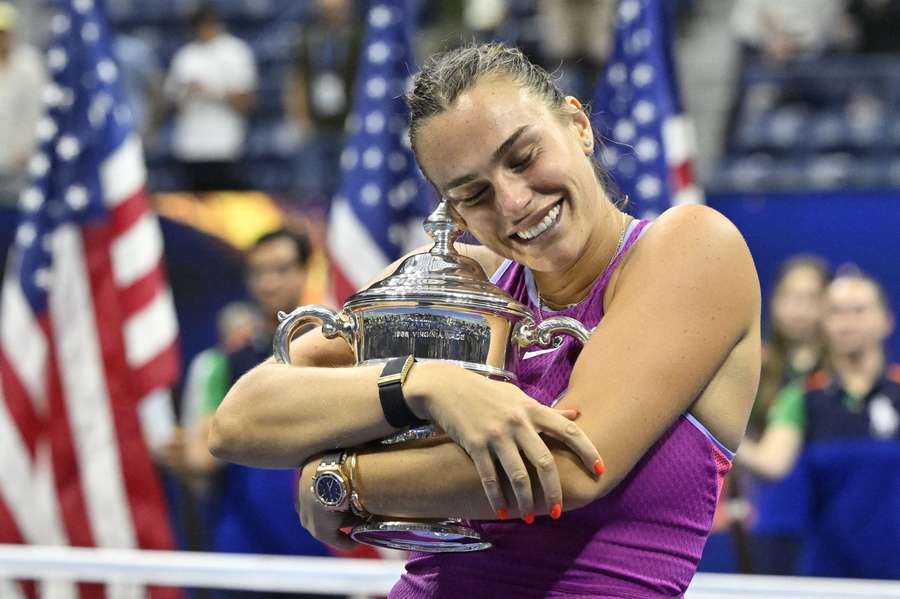 Aryna Sabalenka celebrates with the trophy