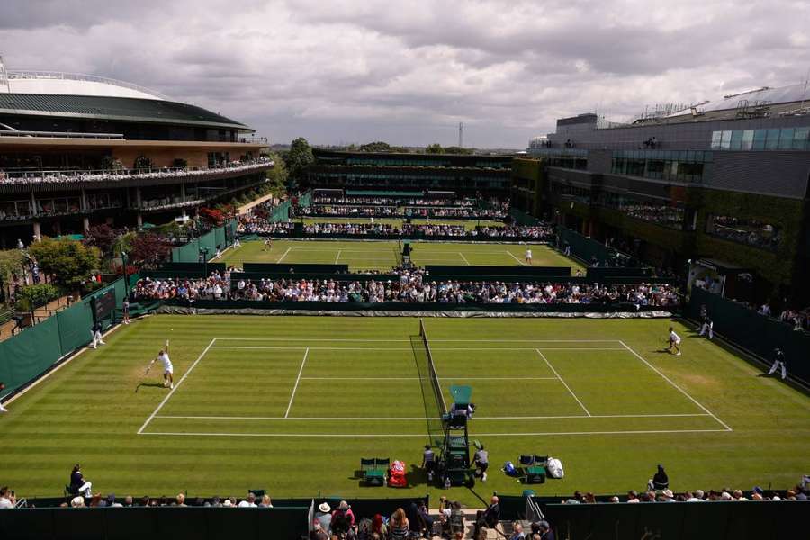 Perfectly-manicured green lawns with crisp white lines are the worldwide image of the tournament