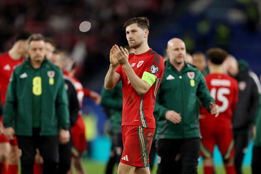 Wales captain Ben Davies applauding the home support