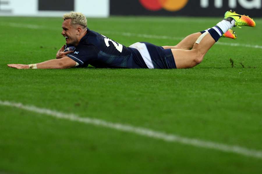 Scotland's wing Darcy Graham dives and scores a try