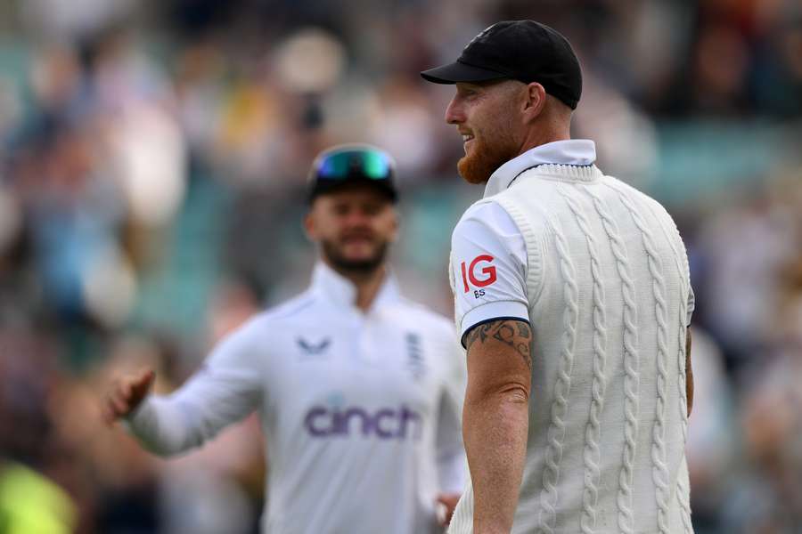 England captain Ben Stokes smiles after taking a great catch to dismiss Australia's Pat Cummins