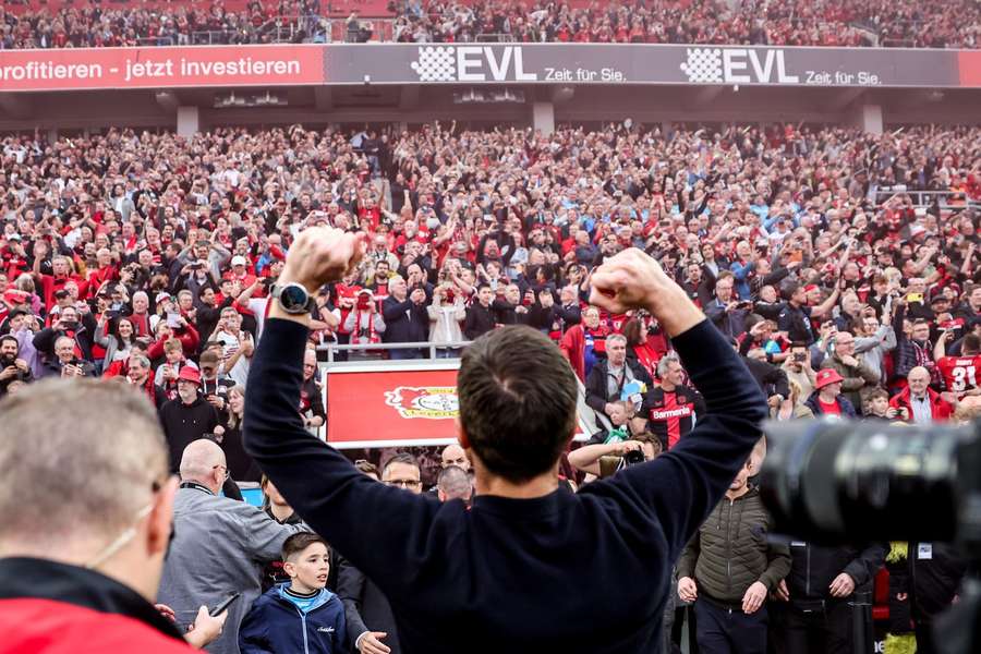 Xabi Alonso celebrates in front of the Bayer Leverkusen fans after winning the Bundesliga title