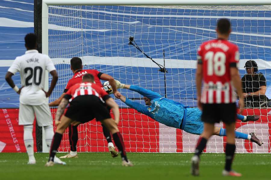 Real Madrid goalkeeper Thibaut Courtois dives for the ball