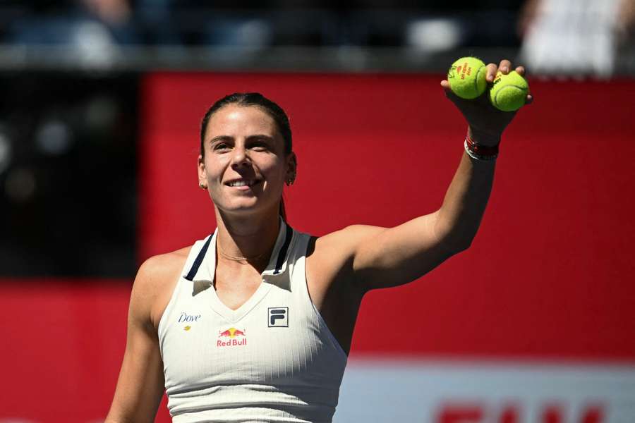 Emma Navarro waves to the crowd after defeating Paula Badosa