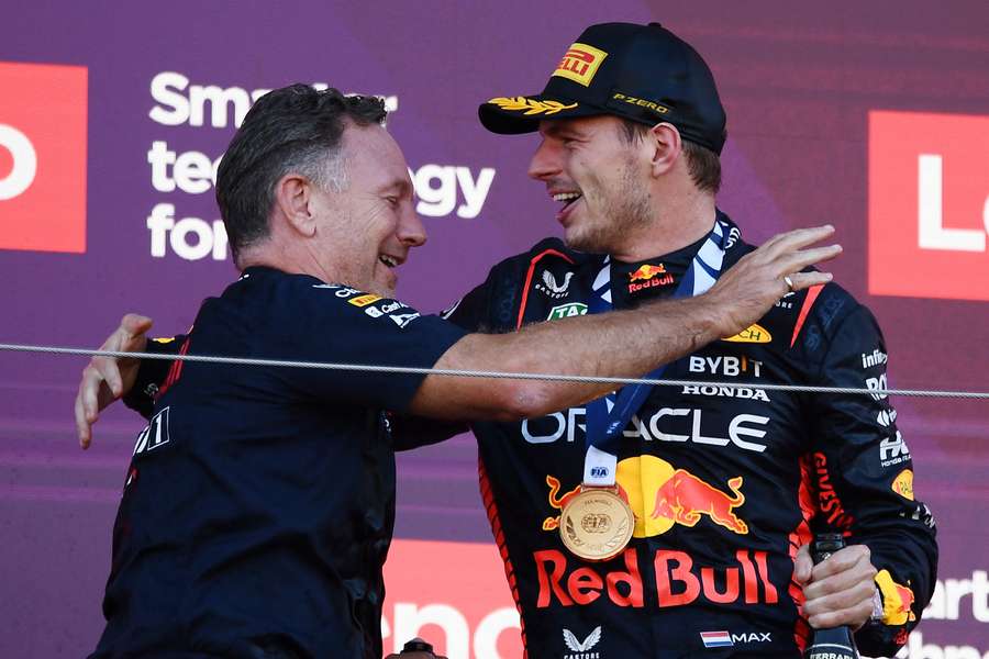 Red Bull's Max Verstappen (R) celebrates his victory with team principal Christian Horner (L) on the podium