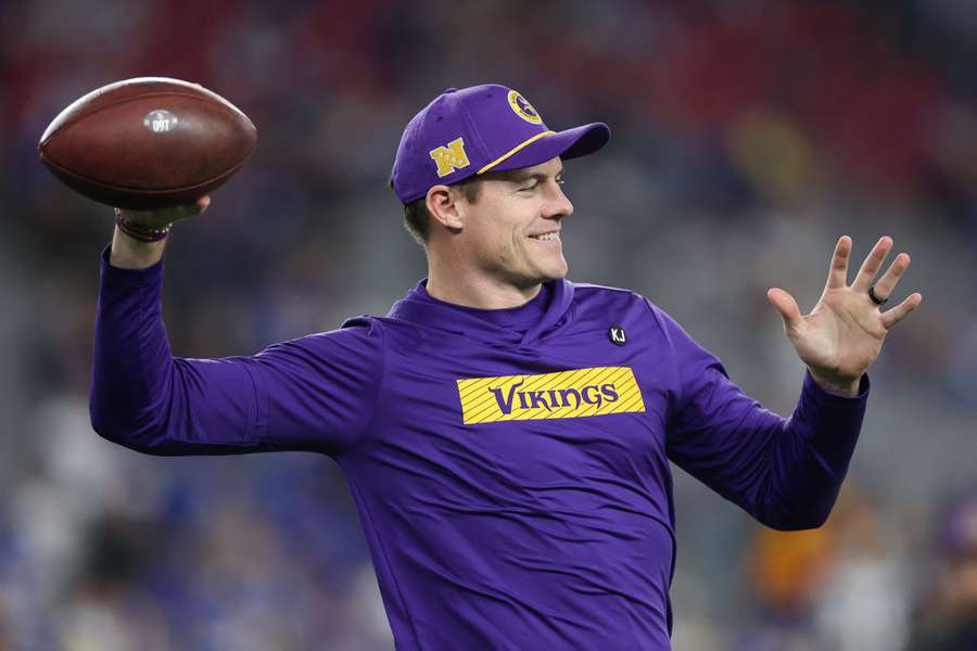 Minnesota Vikings head coach Kevin O'Connell tossing around a ball before 2025 wild card game