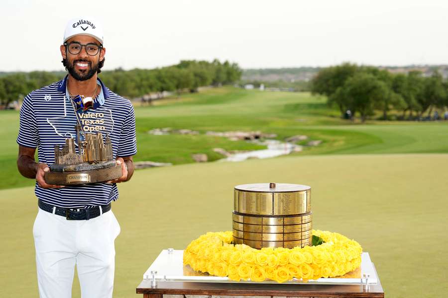 Akshay Bhatia poses with the trophy after winning the Texas Open