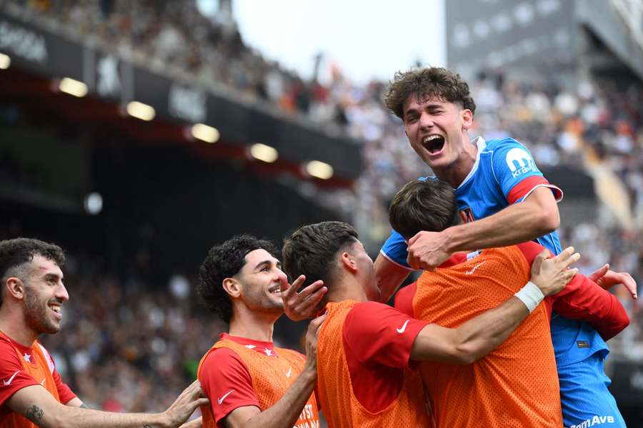 Miguel Cubo celebrates scoring on his debut with teammates