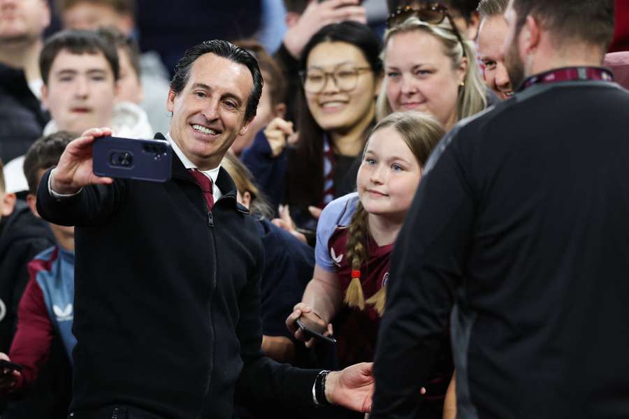 Aston Villa's Spanish head coach Unai Emery poses for pictures with fans during a lap of honour