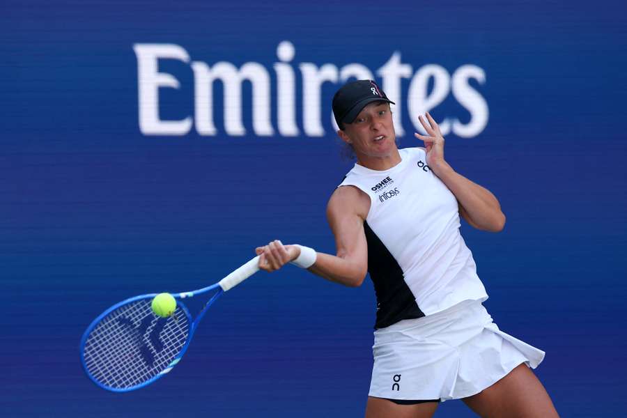 Iga Swiatek blasts a return to Emiliana Arango in a straight-sets first-round win at the US Open