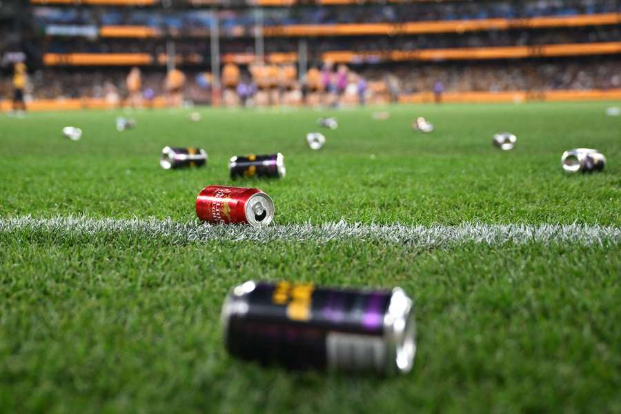 Cans of alcohol - some empty and some not - were thrown at AFL umpires by Hawthorn supporters on Saturday night.